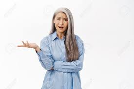 Confused Japanese Middle Aged Woman Looking Questioned And Frustrated,  Shrugging Shoulders With Disappointed Face Expression, Asking What,  Standing Over White Background Stock Photo, Picture and Royalty Free Image.  Image 192331156.