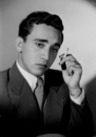 Fernando Medino, de frente con mirada baja y cigarrillo en mano, retrato