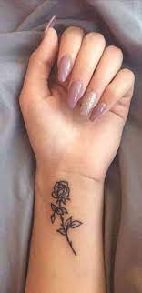50 Tattoo Ideas For Women Looking For Big Or Small Meaningful Designs Small Rose Wrist Tattoo Rose Tattoos On Wrist Wrist Tattoos For Women