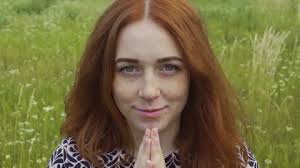 Attractive red haired woman reaches hands inviting sharing happiness joy of  life