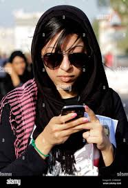 In this picture taken June, 7, 2012, human right activist Zainab al-Khawaja  tweets during an anti-government protest in Sitra, Bahrain. Al-Khawaja was  convicted and sentenced Wednesday to two months in prison for