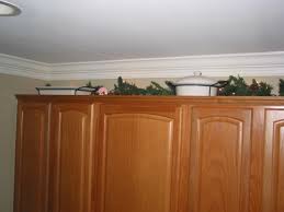 If you have enough room, you can hang items on the wall in the space above your cabinets. Someone Wants To Know What Do I Put On Top Of Kitchen Cabinets Imagine That Interior Decorating
