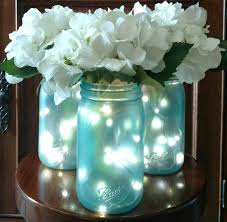 15 Thrifty Mason Jar Table Decorations And Centerpieces That Look Simply Amazing Mason Jar Fairy Lights Mason Jar Flower Arrangements Mason Jar Flowers