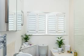 People project a fake window onto a wall. Faux Wood Plantation Shutters Interior Plantation Shutters