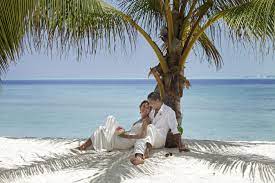 Relaxing Under A Palm Tree After Renewing Their Vows At Kandooma Maldives Maldives Wedding Ocean Wedding Maldives
