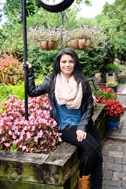 Ready made · new releases · top sellers A Beautiful Teen Girl Sitting On Rustic Wood Flowerbox Frame Holding The Post Of A Large Clock Stock Photo Picture And Royalty Free Image Image 46937166
