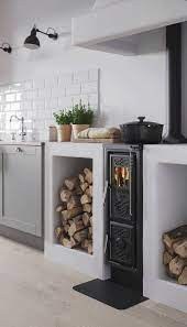A traditional style kitchen in boston, massachusetts with a cozy brick fireplace. Scandinavian Traditional Kitchen Wood Cook Stove Kitchen Kitchen Fireplace Wood Stove Cooking