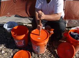 hand washing laundry in a bucket five