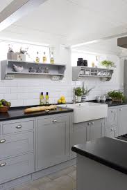 Swedish Hand Painted Kitchen In Grey With White Tiles Glass Jars And Belfast Sink Kitchen Renovation Kitchen Remodel Grey Kitchen Cabinets