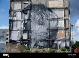 Kreuzberg, Berlin, Germany. 31st July, 2013. A Cut Out by street artist  and photographer JR under the motto Wrinkles of the City at the former  East German building ministry on Breite Strasse