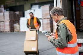 Transport Workers Moving Boxes with Hand Truck and Checking Shipping Order on Tablet - Public Policy Institute of California