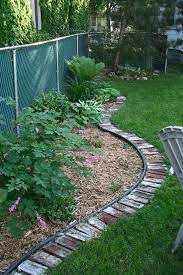Bricks make a really pretty garden border because their rusty red color often looks quite good with the green grass and plants. Garden Beds Man They Re Never Done Deuce Cities Henhouse Brick Garden Garden Edging Brick Garden Edging