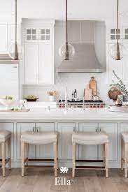 This Two Tone Modern Farmhouse Kitchen Features Ella Countertops Glass Pendant Lights And A Subway Tile B Farmhouse Kitchen Design Kitchen Design New Kitchen