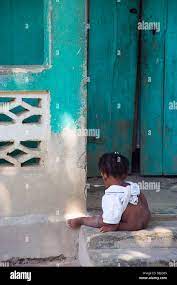 Haiti; Nackte Mädchen sitzen auf der Eingangstreppe Stockfotografie - Alamy