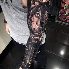 50 Realistic Wolf Tattoo Designs For Men Canine Ink Ideas Wolf Tattoo Design Realistic Wolf Tattoo Wolf Tattoo Sleeve