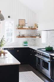 In this beautiful black and white farmhouse kitchen, the space is softened with greige tile and walls. Modern Farmhouse Kitchen In Black And White Town Country Living
