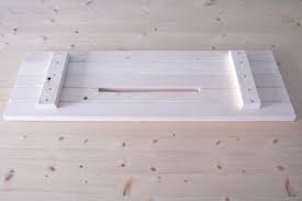 The sticky pads rest on top of the edges of the tub. Sofia Clara Diy Bath Tray