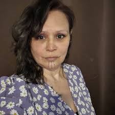 This is a culture vulture named Annika Electra or Annika Lipp, who refers  to herself as “Dancing Blue Dragonfly Woman” and sells tickets to “Sweat  Lodges” at events. When we say we