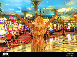 Happy winning caucasian woman at the casino of Las Vegas, Nevada, USA.  Blonde lady enjoying spending money and being lucky enough to win.  Architecture Stock Photo - Alamy