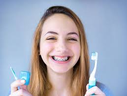 Learn how to properly brush and floss your teeth with braces. Importance Of Gum Care With Braces Orthodontic Associates