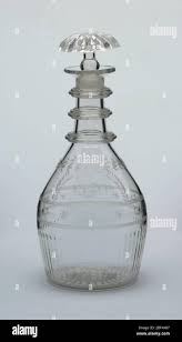 Decanter and stopper. Bulbous body, ring of molded vertical fluting bottom  carrying over onto bottom; engraved border with initials I B H; 3 triple  neck rings, everted lips; molded mushroom shaped stopper,