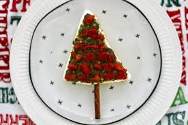 Using a sharp knife, make the christmas tree branches by cutting approximately 1 inch horizontal slices down the right and left side of the tree leaving the middle of the tree (the trunk) intact. No Bake Cheesy Christmas Tree Dip Appetizer Recipe