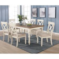 Cozy and inviting dining room with exposed brick wall, a long table and soft chair covers. Prato 7 Piece Dining Table Set With Cross Back Chairs Antique White And Distressed Oak On Sale Overstock 30933945