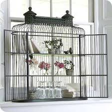 Decorative birdcages can add interest on tabletops, bookshelves, console tables, above kitchen cabinets, or displayed on a baby grand piano. Decorating With Birdcages 12 Creative Ideas For Everyday Use Tidbits Twine Vintage Bird Cage Bird Cage Bird Cages