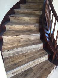 Wood Looking Tile With Newly Stained Banister Laminate Stairs Tile Stairs Diy Stairs