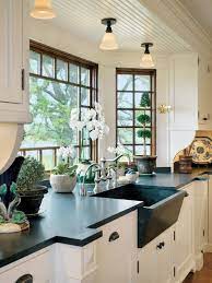 That's because the tiles line up with the hood range on the right hand side, as well as the upper open shelves. Large Kitchen Window Design Ideas Heather Hungeling Design