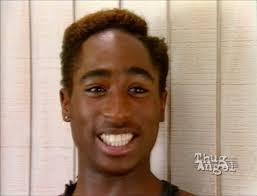 YO! I'm going to say this shit one time and never again. This is TUPAC when  he was 17. Does anyone look or dress how they did when they was a kid?