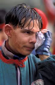 Image of Inger Miller of the U.S. points to family members and