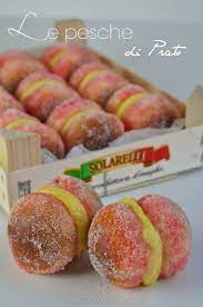 Pesche di prato are round buns made with flour, sugar, yeast, butter and orange juice, soaked in alchermes, cut in half. Le Pesche Di Prato Burro E Malla