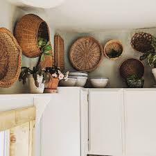 I M Glad There S A Design Trend That Speaks To The Wicker Obsessed Plants And Baskets Are Decorating Above Kitchen Cabinets Above Cabinet Decor Cabinet Decor