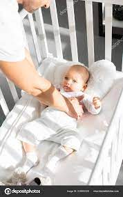Cropped View Father Putting Infant Daughter Baby Crib Free Stock Photo C Vitalikradko 230843228