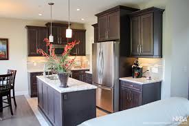 Stained Kitchen With Staggered Heights And Depths Nkba In 2020 Kitchen Cabinets Height Staggered Kitchen Cabinets Best Kitchen Layout