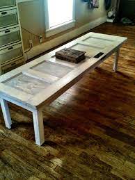 The tabletop is made from solid pine wood and has a butcher block style with visible wood grain and knots for a rustic, antique look. Antique Door We Painted And My Husband Made Into A Coffee Table Door Coffee Tables Coffee Table Barn Door Tables