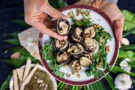 My favorite healthy snack to keep at the office is nuts. Woman Hands Holding Roasted Eggplant Rolls With Walnuts Garlic Coriander Oil Onion Traditional Georgian Food Cold Snack Rolls For Dinner Or Lunch Raw Vegan Vegetarian Healthy Food Buy This Stock Photo