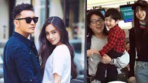 Angelababy runs ahead with her own luggage at the airport. Angelababy Huang Xiaoming S Son Looks Just Like His Dad When He First Started Out In Showbiz