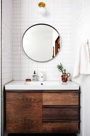 Round Mirrors Are The Next Big Thing For The Bathroom Wood Bathroom Vanity Bathroom Inspiration Round Mirror Bathroom