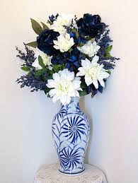 Silk flower arrangement with feathers. Pin On Flower Arrangements