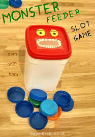 Monster Feed Me Bottle Lids Slot Game For Baby And Toddler Infant Activities Toddler Fun Toddler Activities