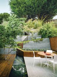Slideshow How To Make Your Tiny Yard Feel Spacious Dwell Sloped Backyard Backyard Design Outdoor Design
