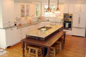 The design of this kitchen island matches the style of the main kitchen cabinets in white, but tops it with black granite instead of white solid surface for added. 15 Beautiful Kitchen Island With Table Attached Home Design Lover