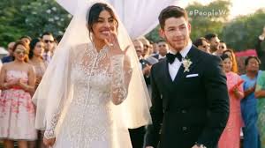 Priyanka chopra and nick jonas pose for photos during their wedding reception. Priyanka Chopra S Wedding Dress Details Arabia Weddings