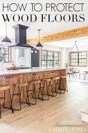This warm engineered wood floor also contrasts perfectly with the lighter wood countertops for a complete look, and the sophisticated feel of the smoked oak floors brings the minimalist design of this kitchen to life. How To Protect Wood Floors Maison De Pax Hardwood Floors In Kitchen Hardwood In Kitchen Wood Floor Kitchen