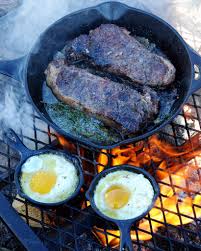 Image result for steak and beer on a campfire