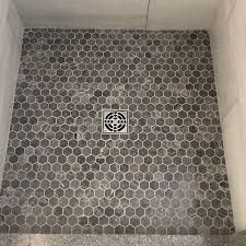 Custom Tile Shower Bases From Natural Stone To Porcelain So Many Options Schlutersystems Porcelain Hexago Custom Tile Shower Shower Bases Shower Tile