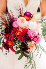 The bride is the picture of natural grace in a wreath of pale lisianthus buds threaded with cosmos. Bright Summer Wedding Bouquets Arabia Weddings