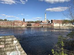 The Former Scott Paper Mill With The Kennebec River In The
